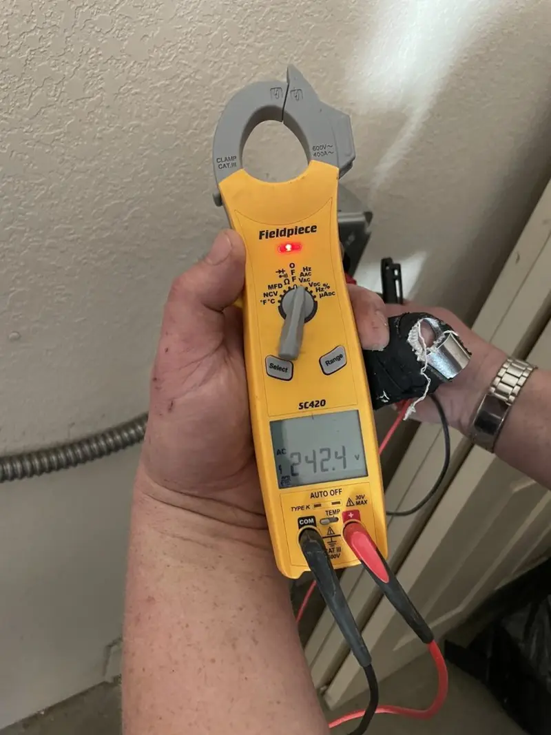 Voltage testing with clamp meter during Outlet Installation in Mayfield